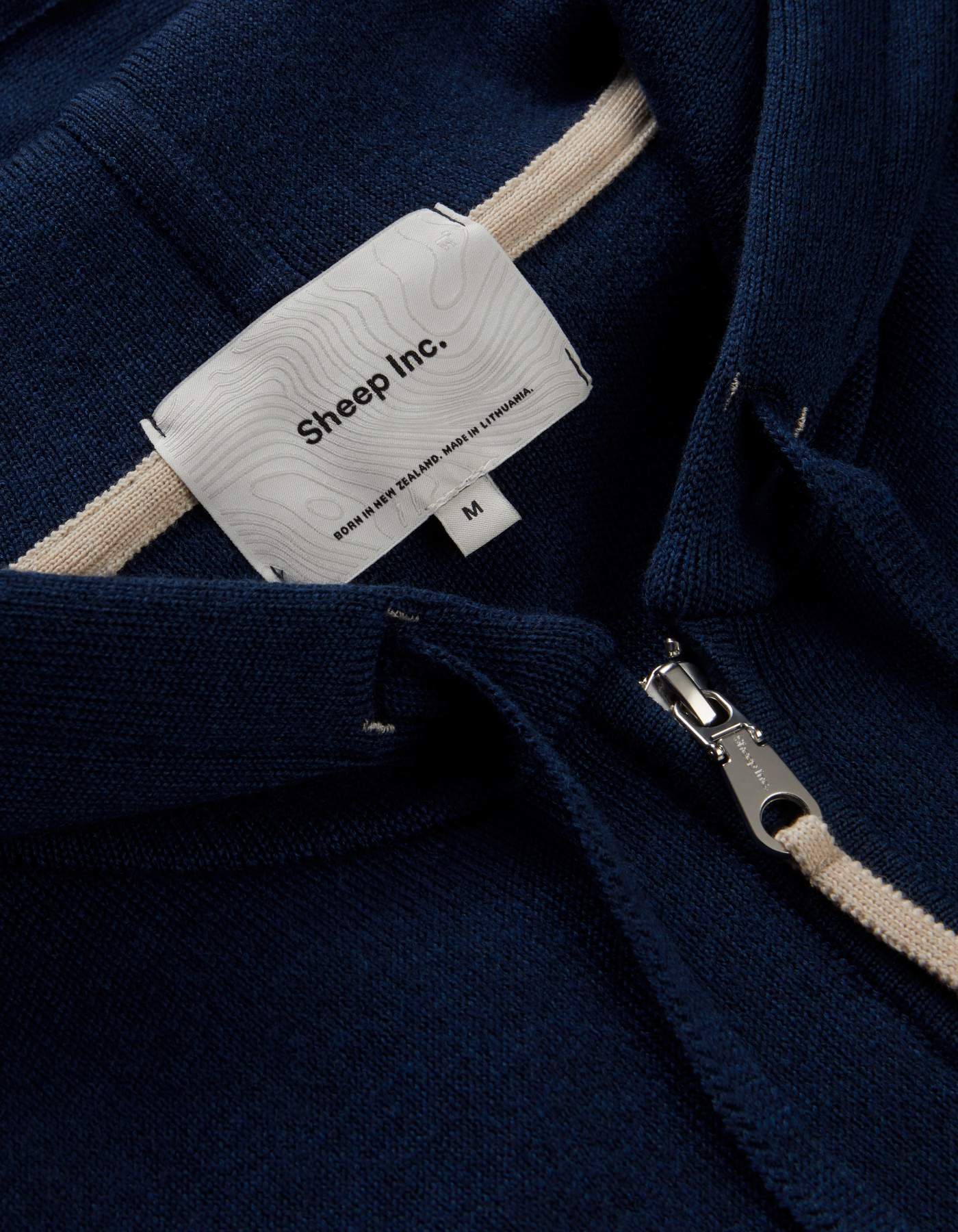 Woven label — Born in New Zealand. Made in Lithuania.